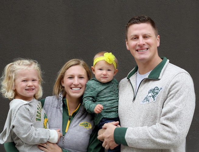 Dr. Vetter, your Fargo dentist with his wife and two daughters all wearing Bison gear. 