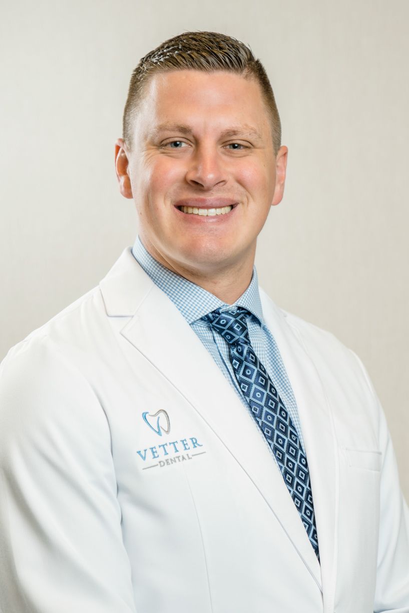 Dr. Vetter, your Fargo dentist, smiling and wearing a white dental coat