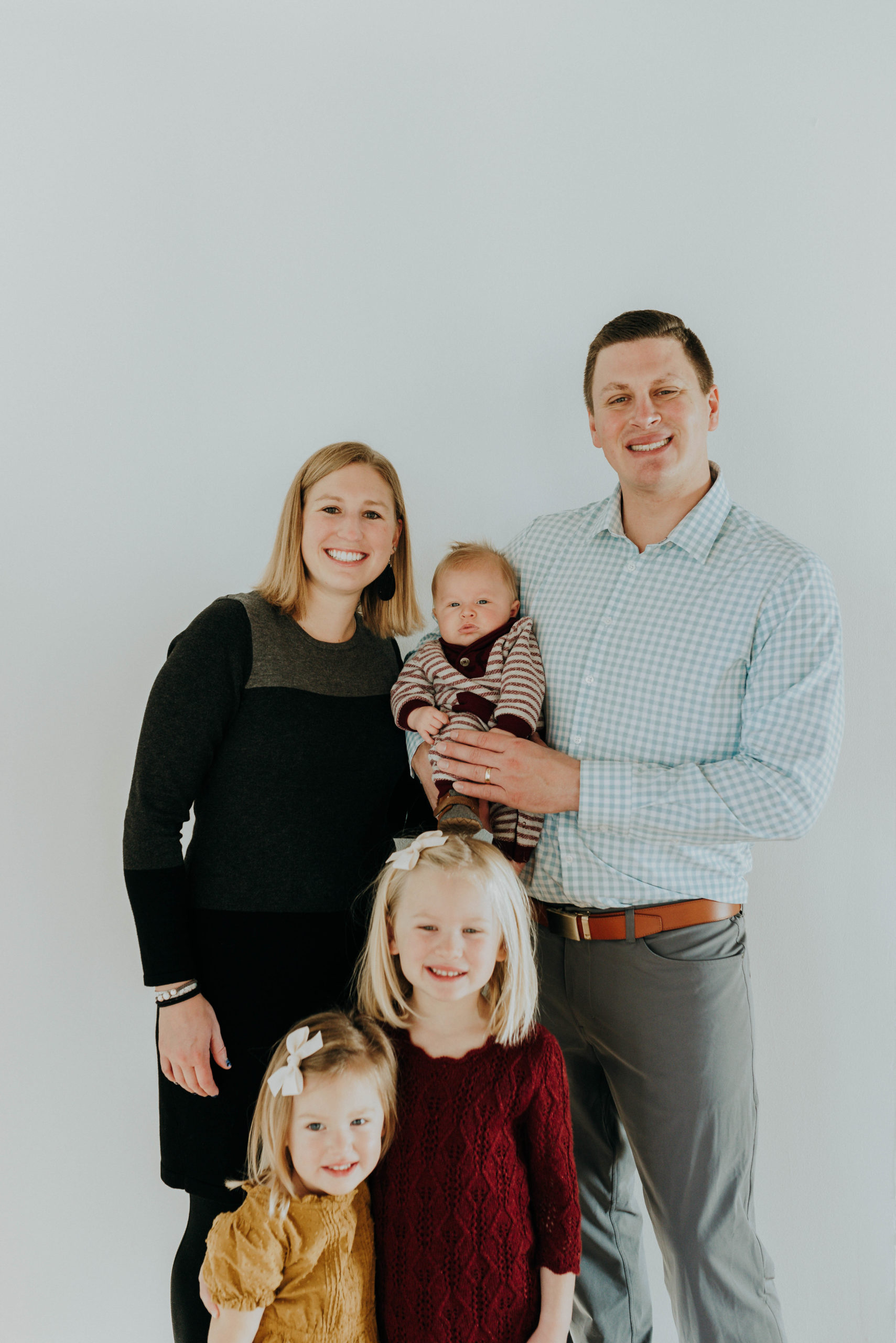 Dr Vetter, a dentist in Fargo, ND holding his young daughters 